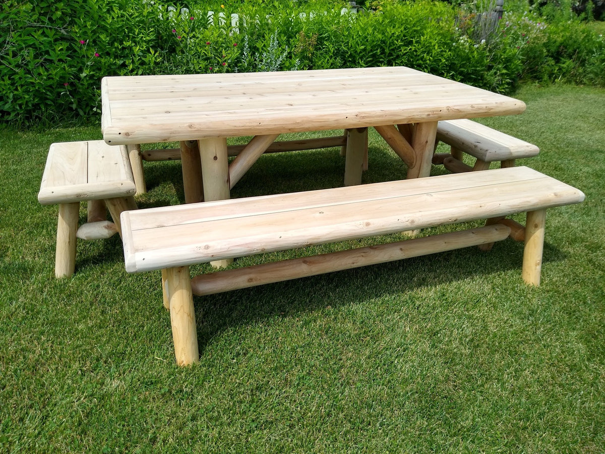 Outdoor picnic table with two benches, light wood tabletop and slatted bench seats