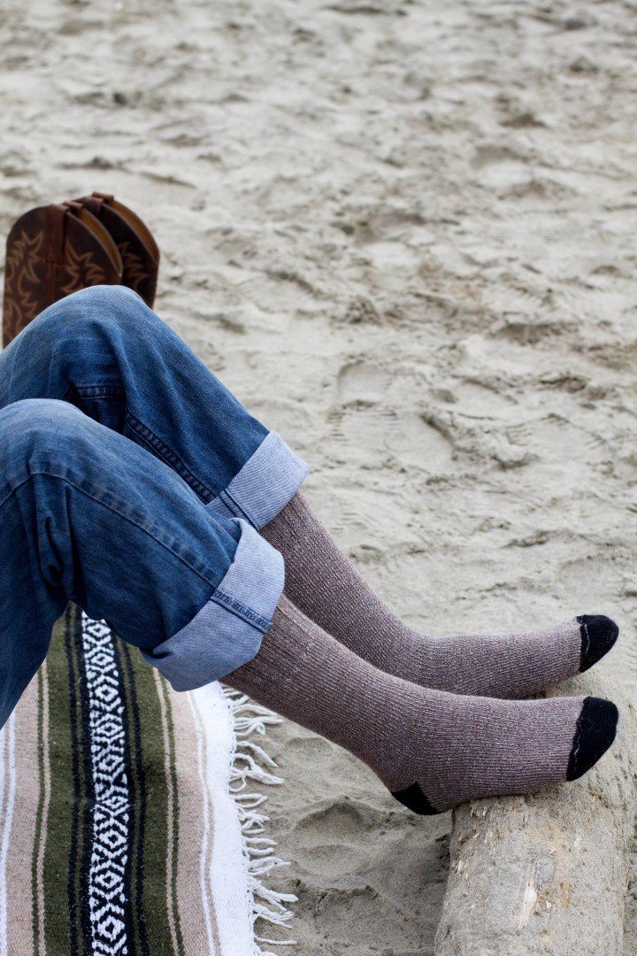 Heather grey alpaca socks with dark navy toe on outdoor step