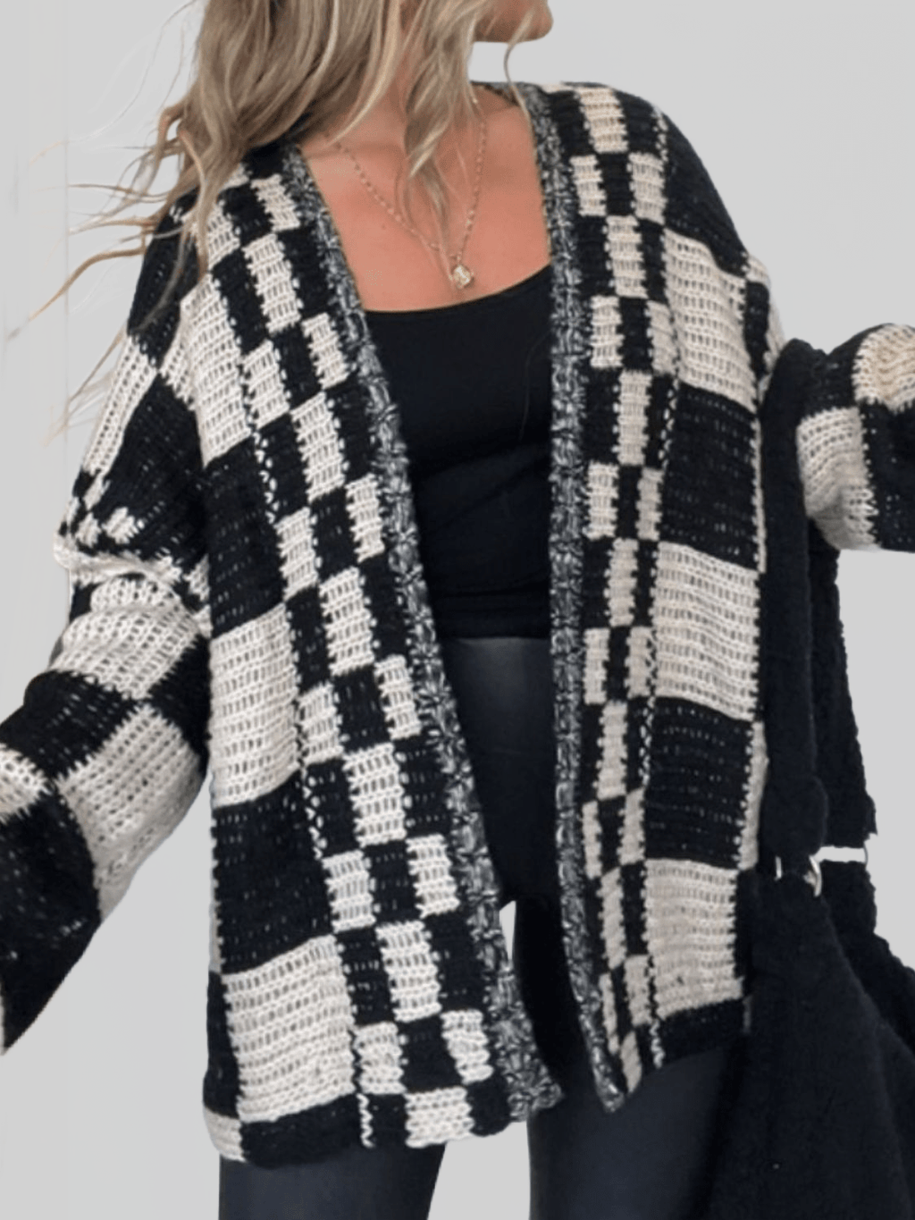 Black and cream check plaid open-front cardigan with long sleeves, draped front