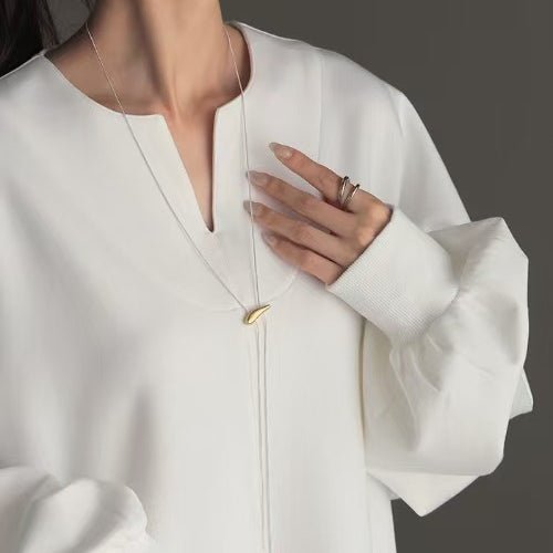 Oversized cotton sweatshirt tunic neckline detail, white v-neck and button placket