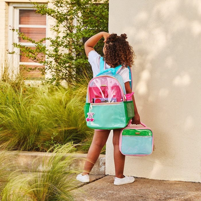 Clear jelly backpack set in aqua and green with pink trim, toddler carrying it