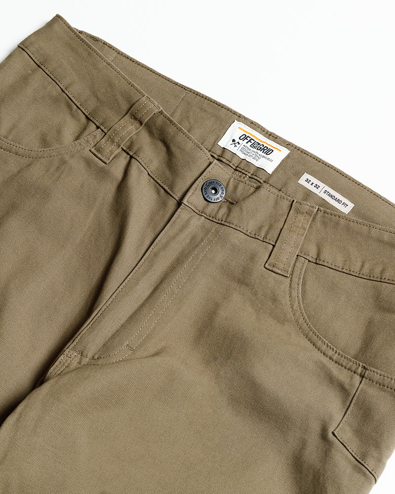 Coyote tan pants waistband close-up with button, zipper, and belt loops