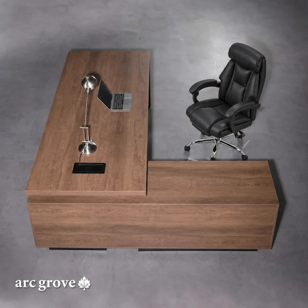 Top view of brown oak L-shaped executive desk with black cutout and lamp holders