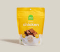 Open Farm chicken dehydrated dog treats pouch, yellow bag with chicken snack pieces
