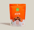 Dehydrated pork dog treat pouch, orange front with Open Farm logo and treat pieces