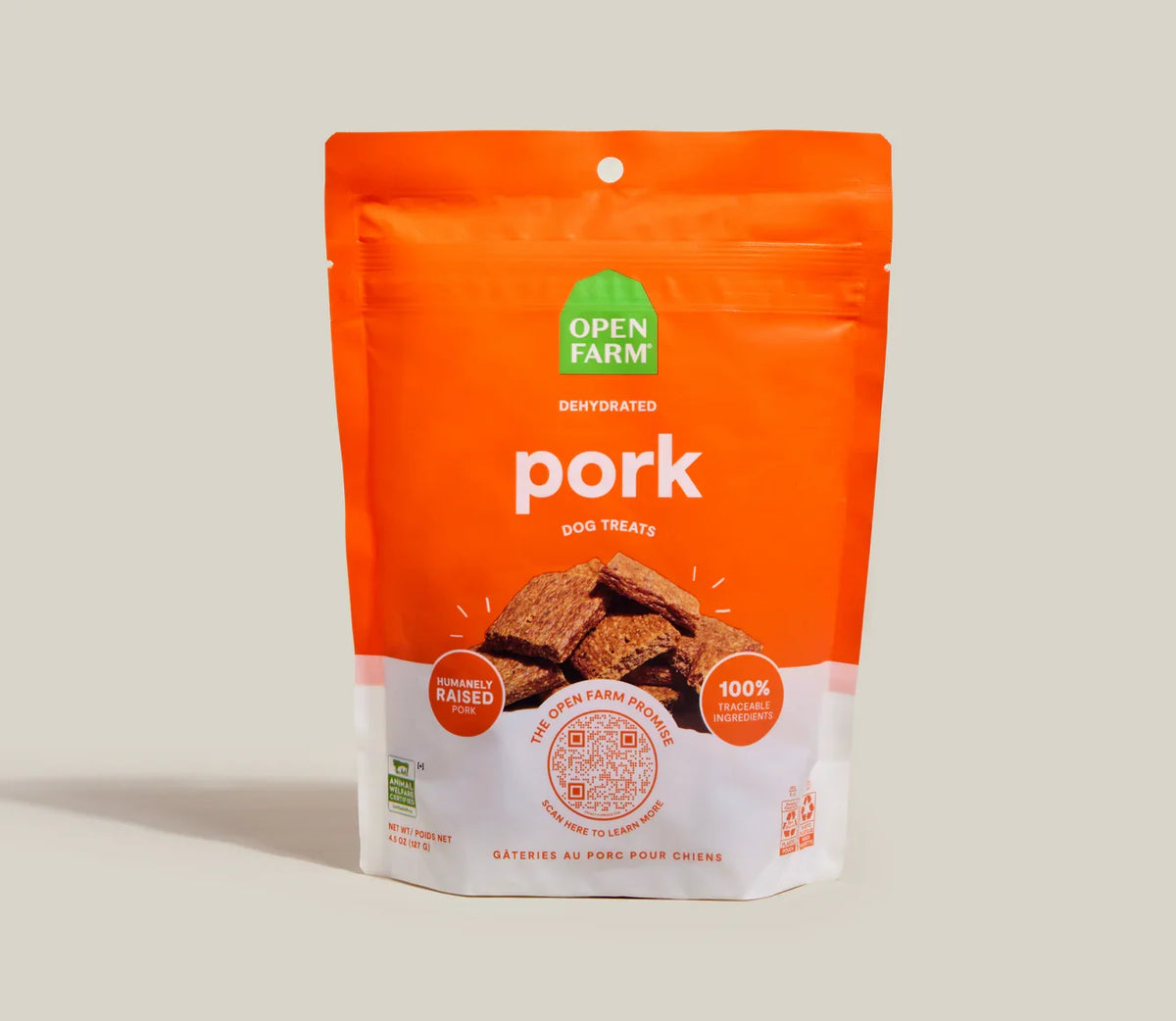 Dehydrated pork dog treat pouch, orange front with Open Farm logo and treat pieces