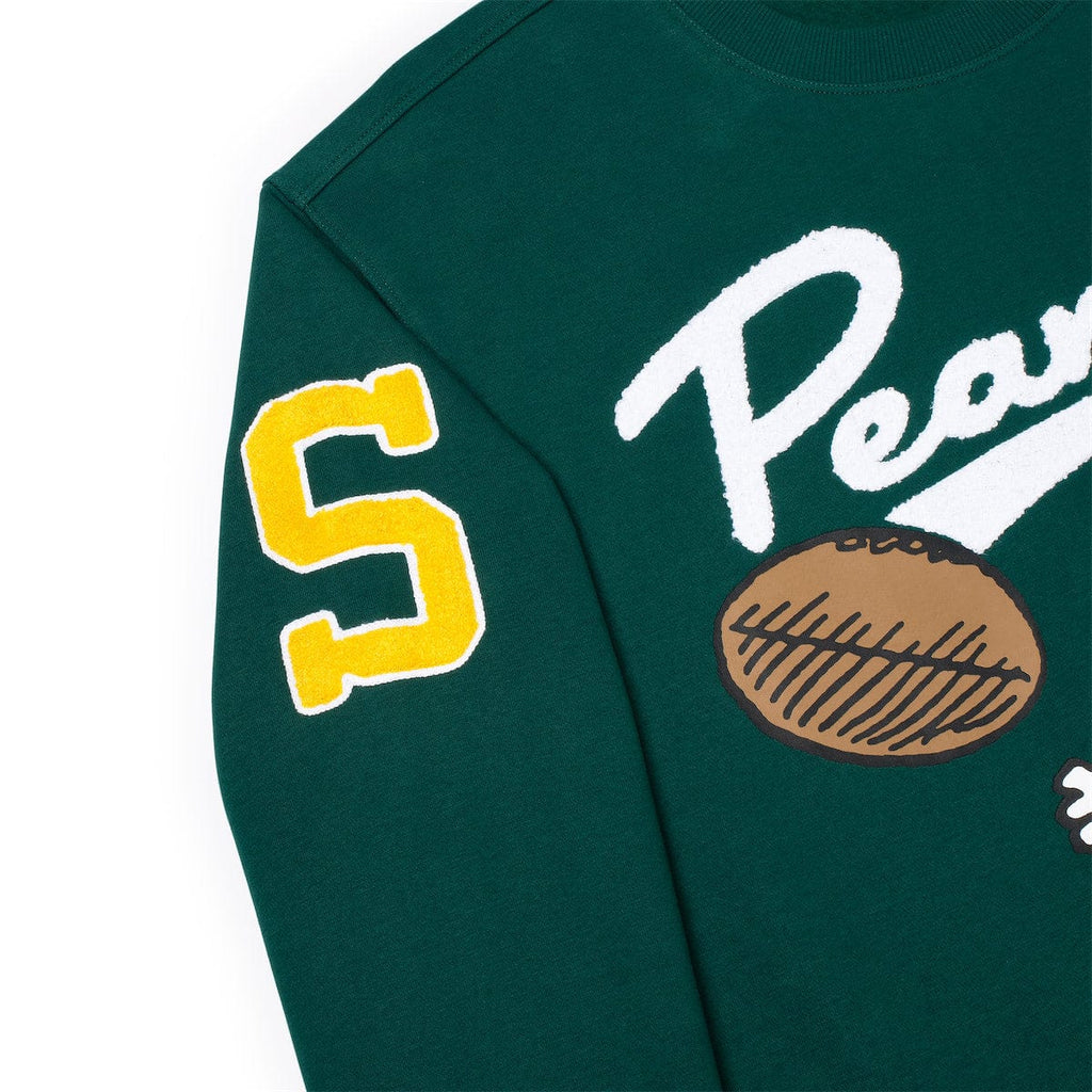 Green crewneck sweatshirt close-up: yellow number 5 patch and Snoopy graphic