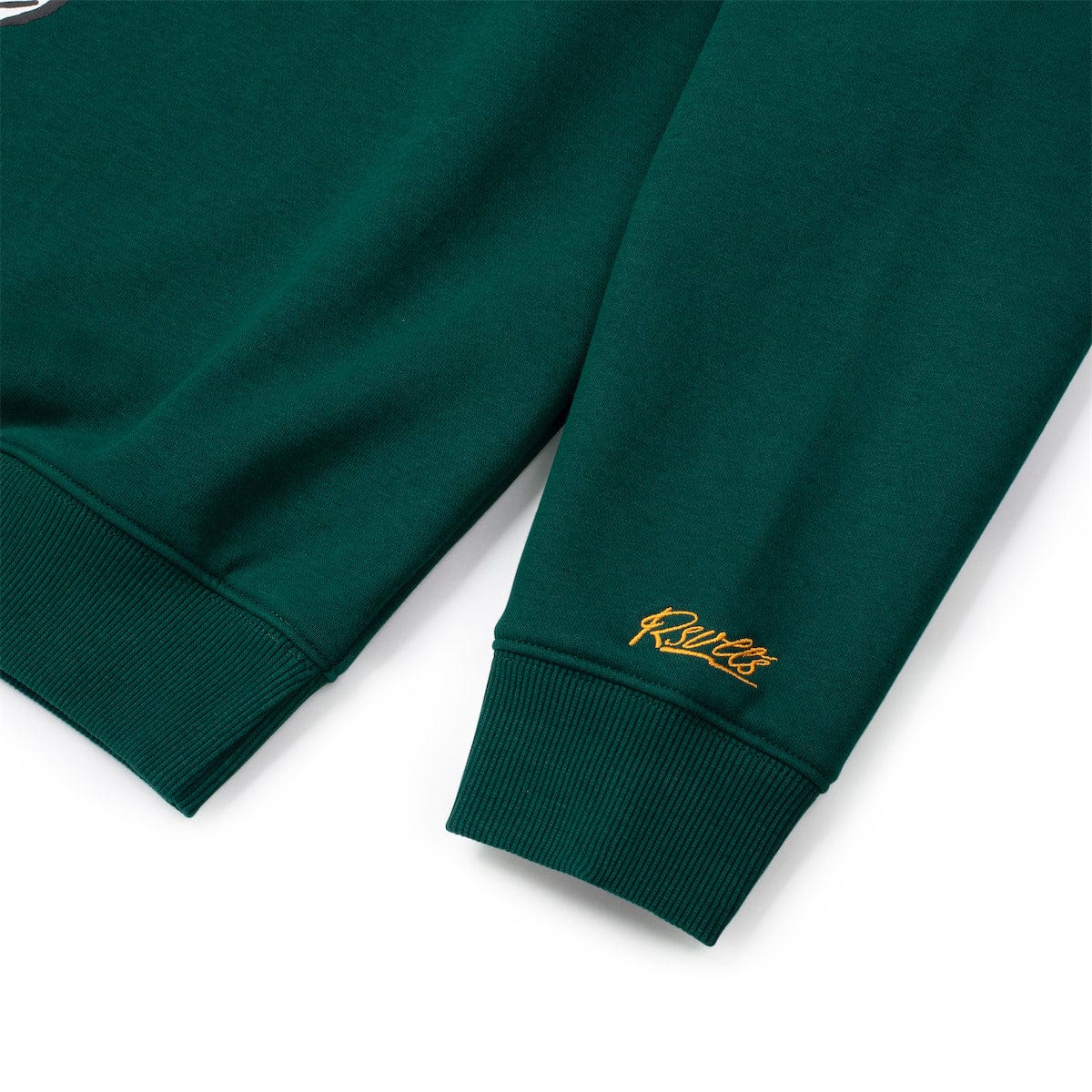Green crewneck sweatshirt sleeves with ribbed cuffs and small gold logo
