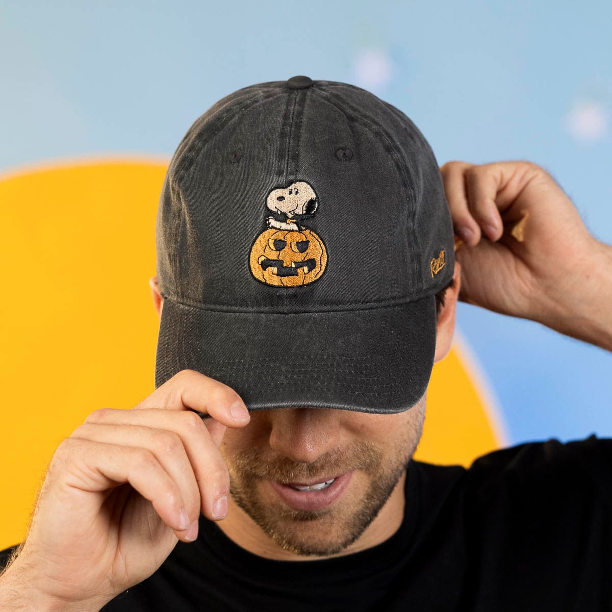 Charcoal dad hat with Snoopy and pumpkin graphic, front view