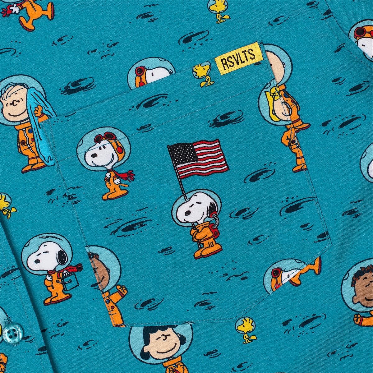 Close-up of teal Peanuts-print short-sleeve shirt with an American flag graphic