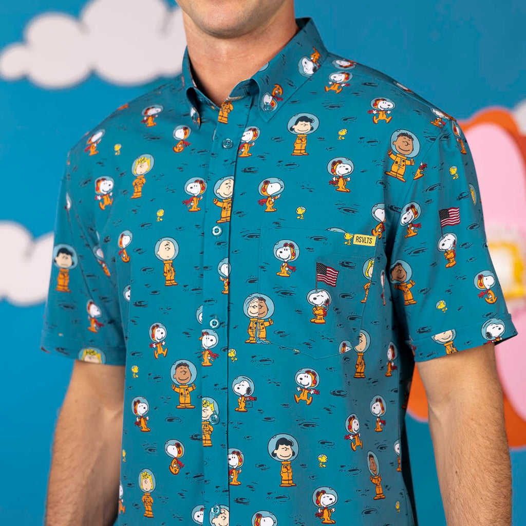 Teal Peanuts character print short-sleeve button-up shirt on a man, chest view