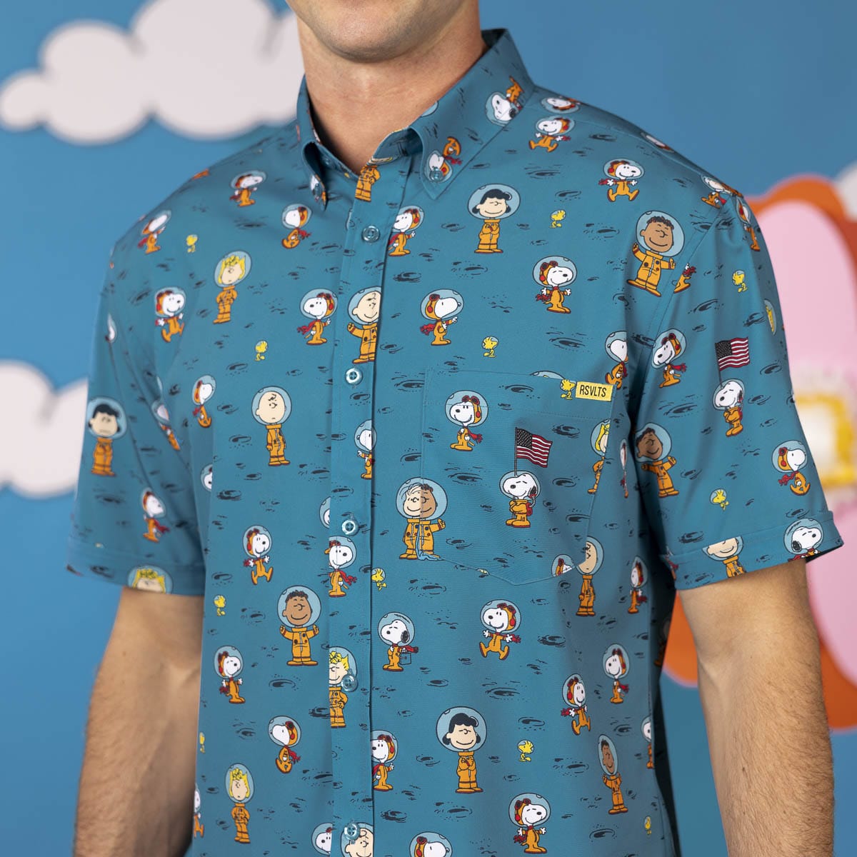 Teal Peanuts character print short-sleeve button-up shirt on a man, chest view