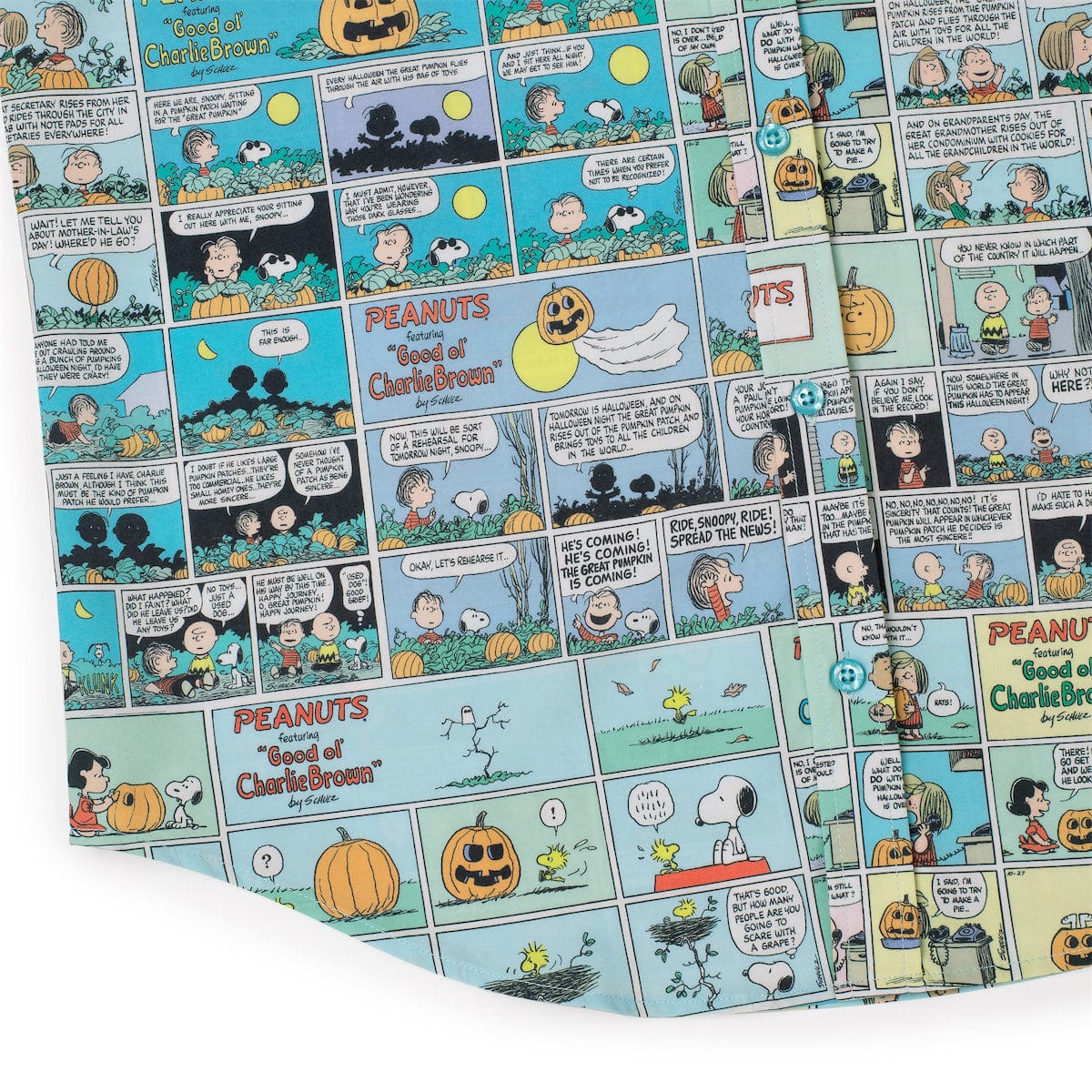 Peanuts comic strip pattern on light blue fabric with pumpkins and speech bubbles