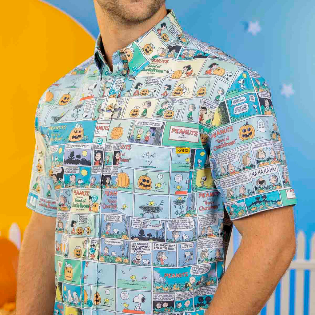 Light blue Peanuts comic print short sleeve shirt on a man’s torso