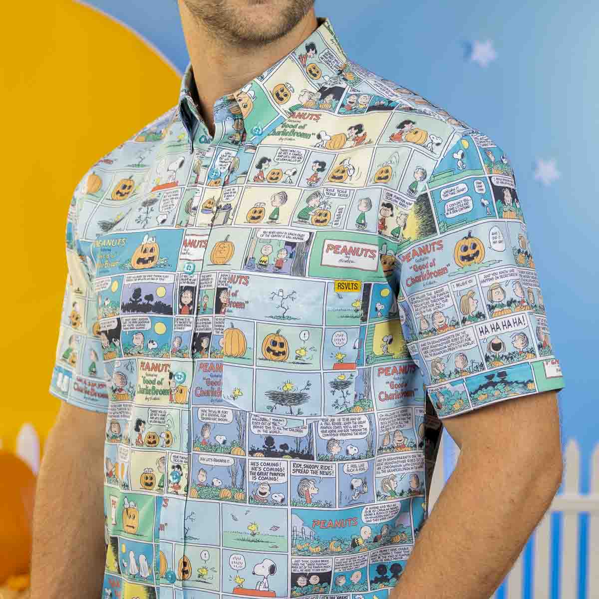 Light blue Peanuts comic print short sleeve shirt on a man’s torso