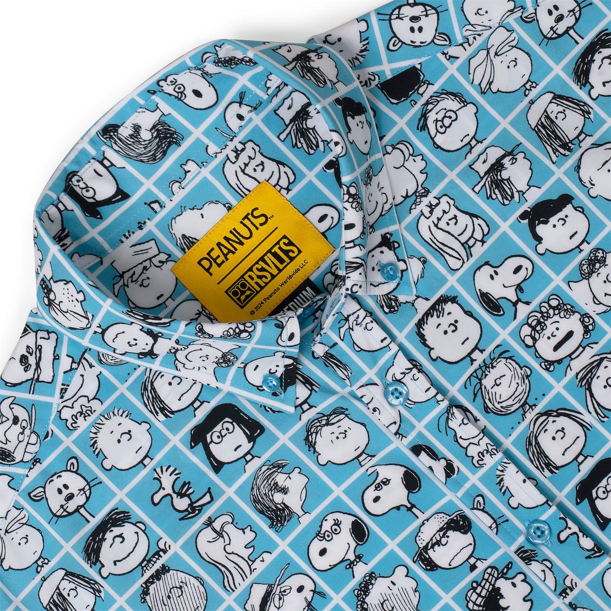 Blue fabric detail of Peanuts characters on checkered grid with yellow brand label