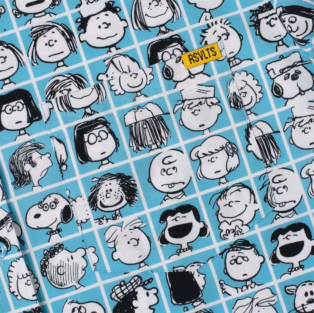 Close-up of blue Peanuts pattern fabric with black-and-white character faces and stripes