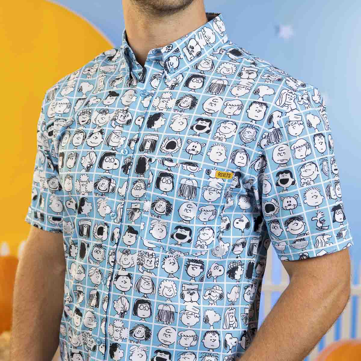 Blue short-sleeve button-front shirt with Peanuts character faces pattern