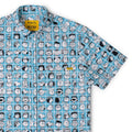 Blue short-sleeve collared shirt with Peanuts character grid print and branded patch at chest