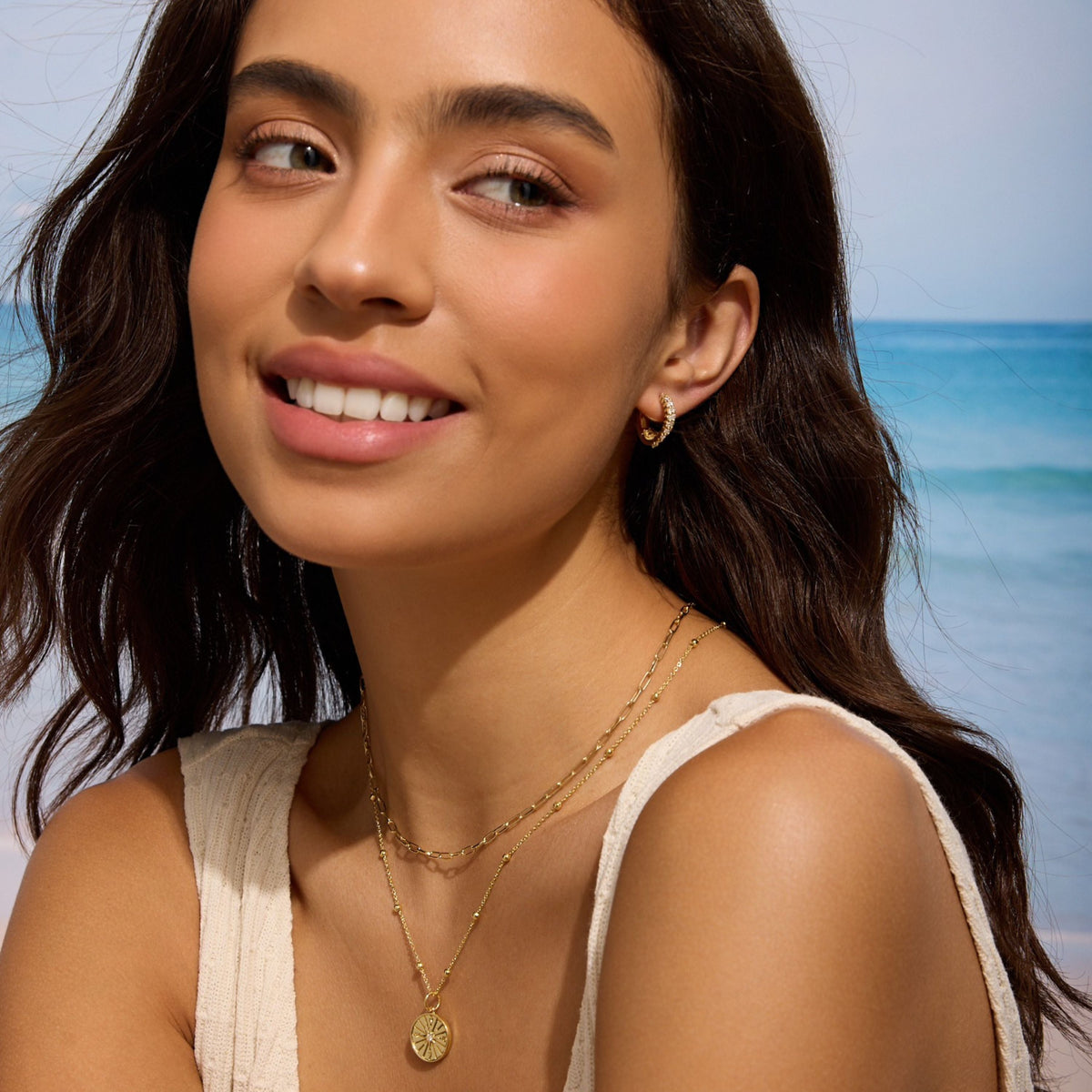 Gold pave hoop earrings worn by model