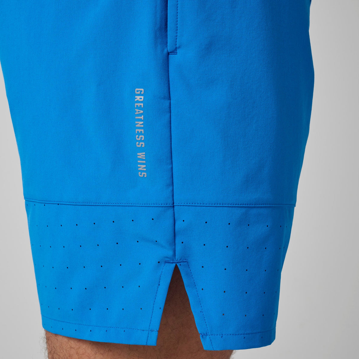 Bright blue shorts with rear seam and vertical printed brand text