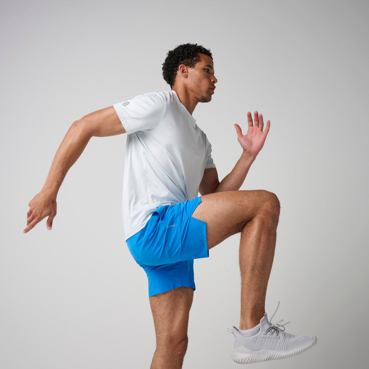 Bright blue training shorts with navy waistband and drawstring, athletic fit
