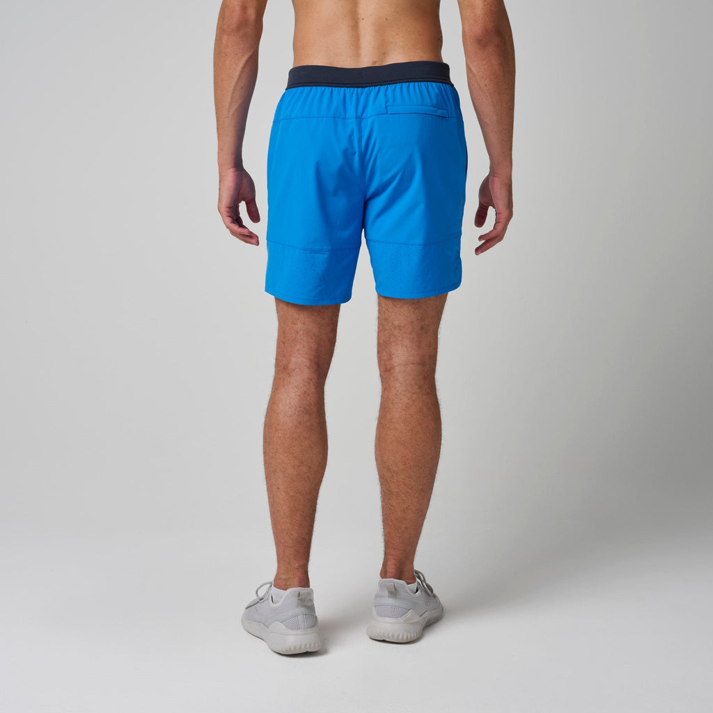Bright blue training shorts with navy waistband, drawstring, and side pockets