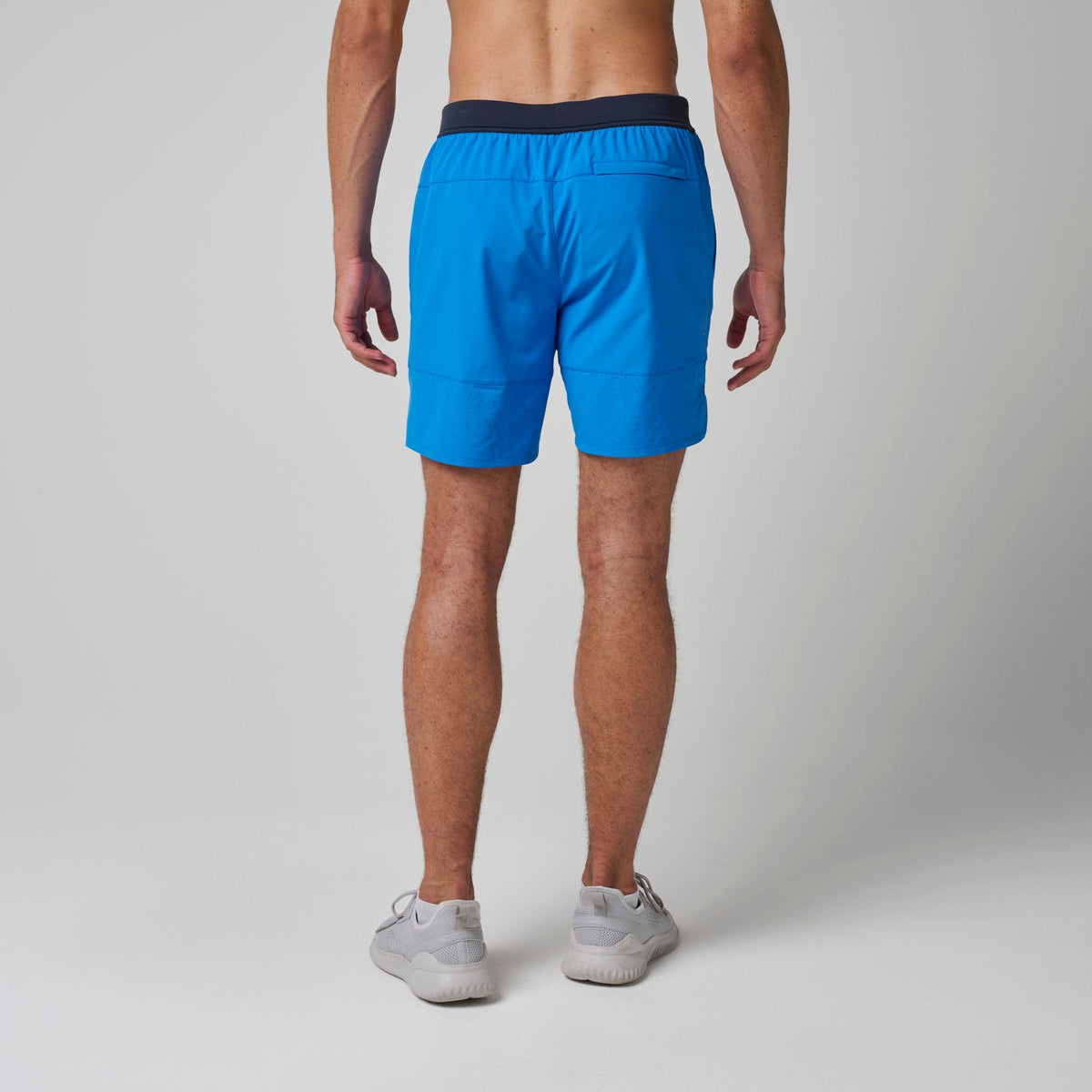 Bright blue training shorts with navy waistband, drawstring, and side pockets