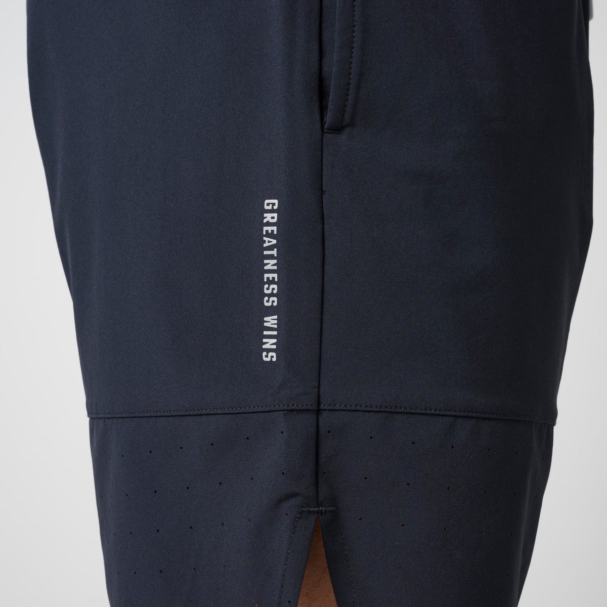 Navy shorts with 'GREATNESS WINS' text on back and vented lower panel.