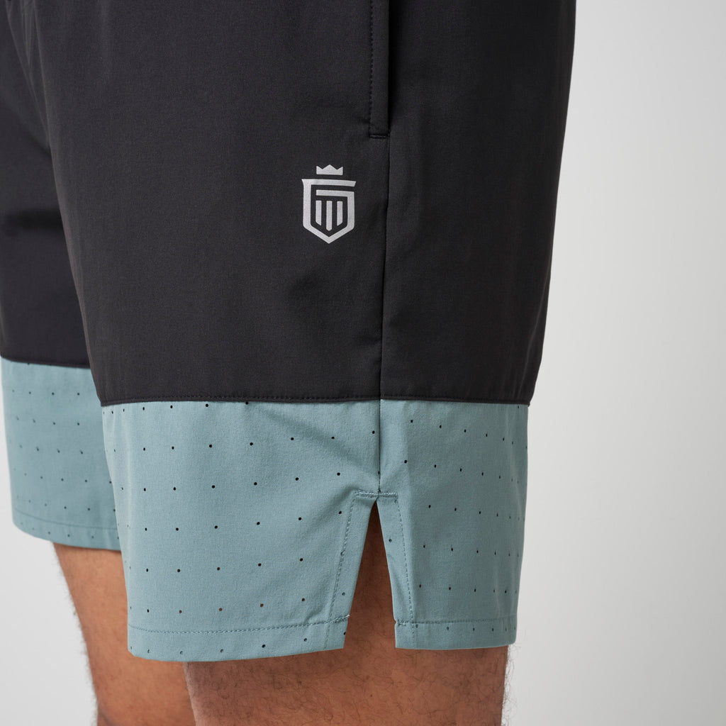 Black and steel blue performance training shorts with shield logo on left leg