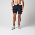 Navy performance training shorts with gray waistband, drawstring, and side pockets.