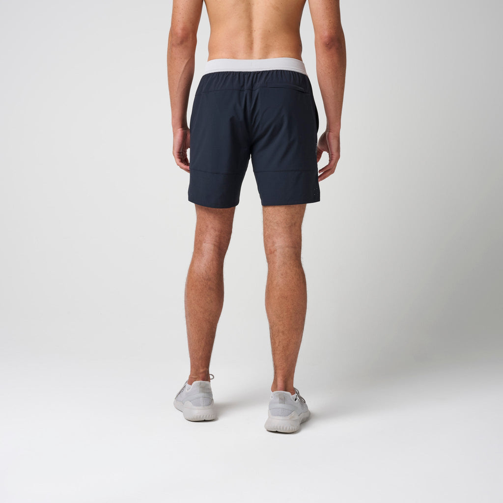 Navy performance training shorts with gray elastic waistband and straight back hem.