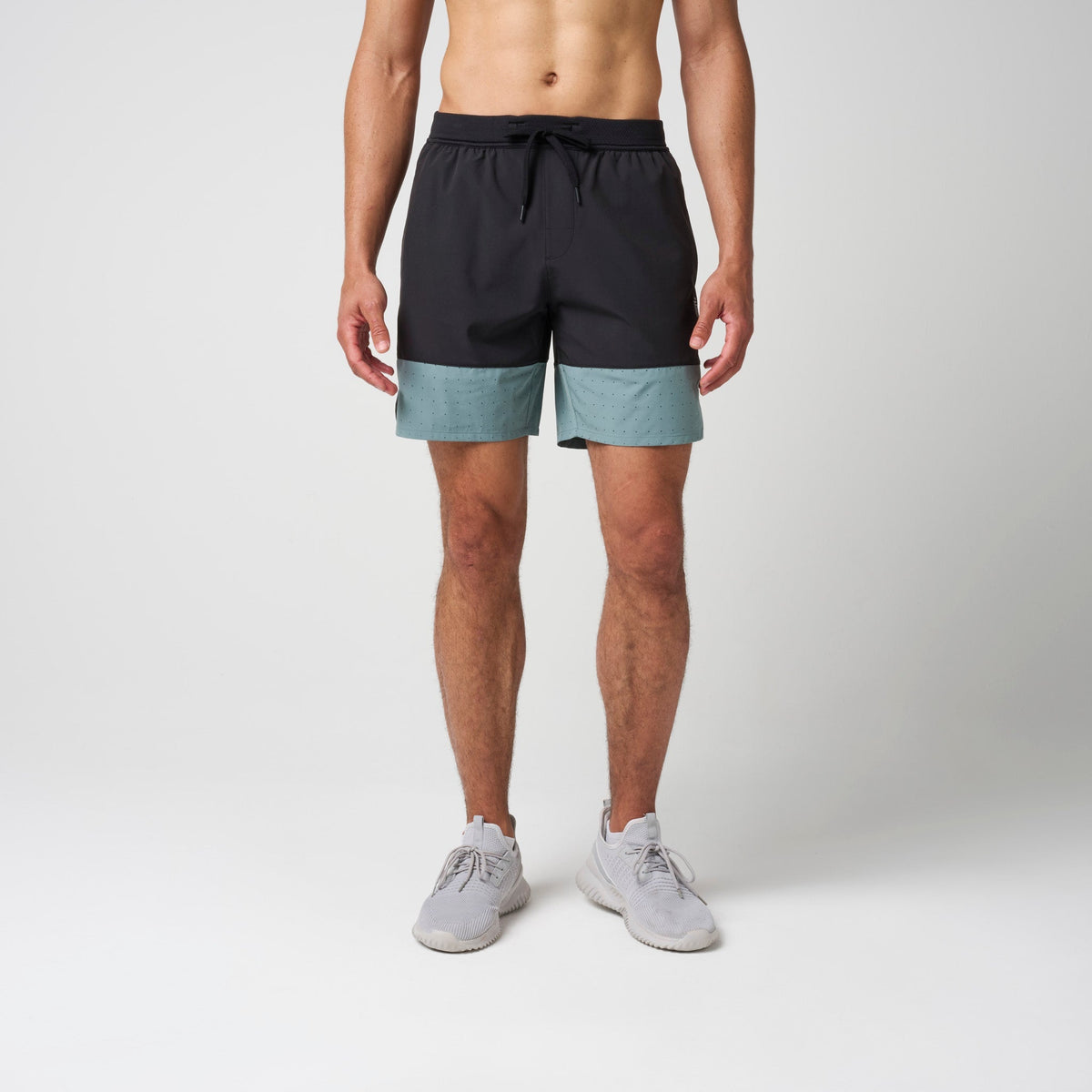 Performance training shorts front view: black top, steel blue lower, adjustable drawstring