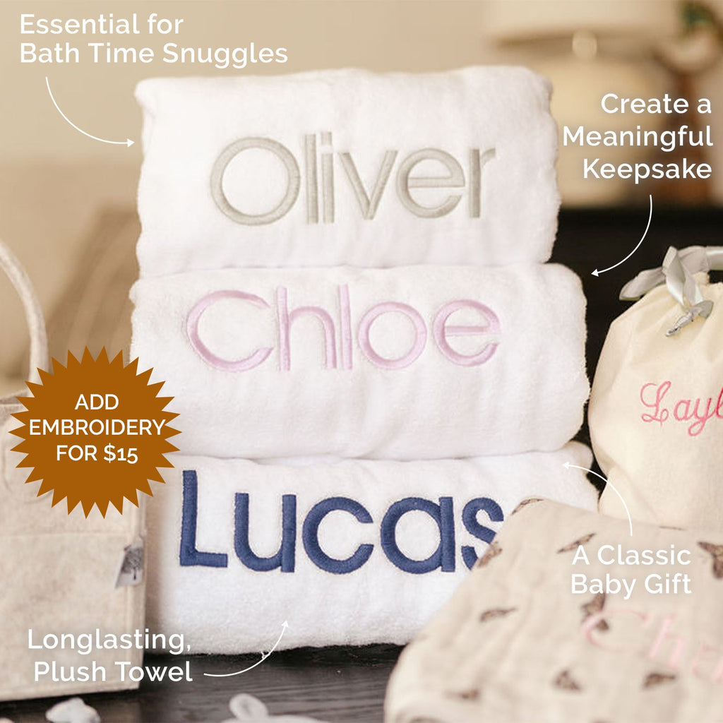 Stack of white hooded towels with embroidered names