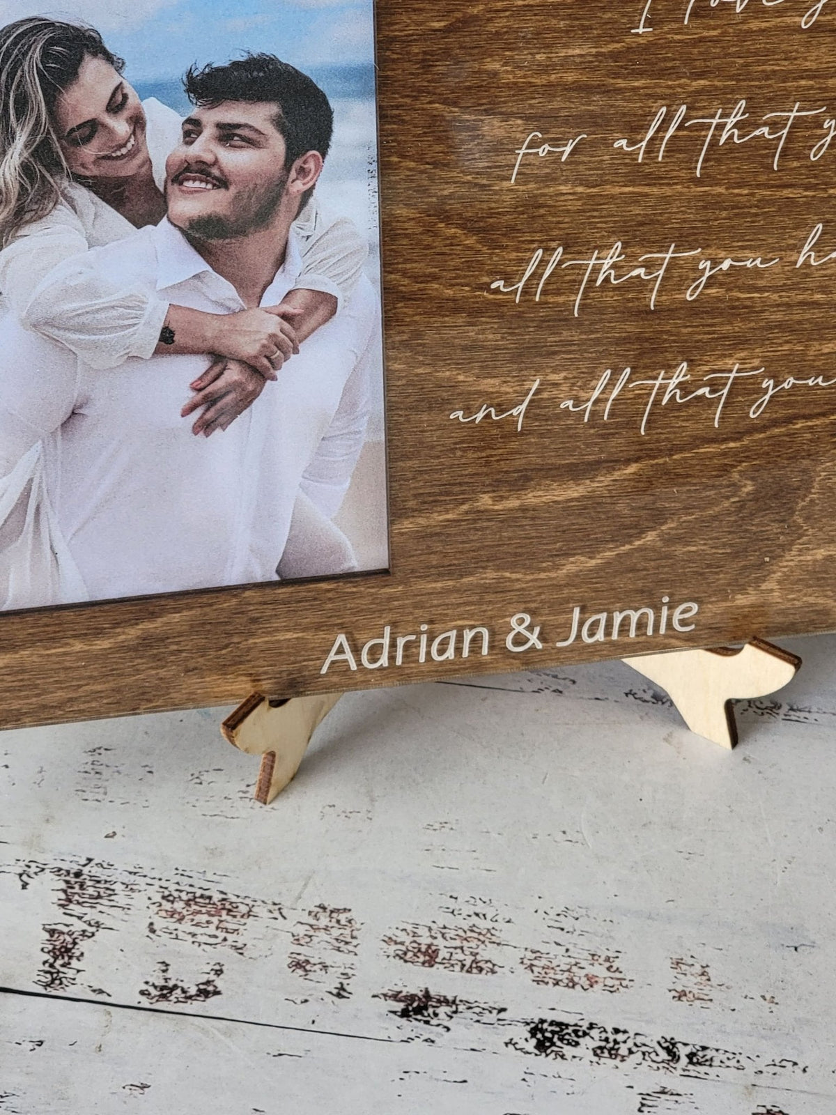 Walnut engraved picture frame close-up with couple photo and handwritten message