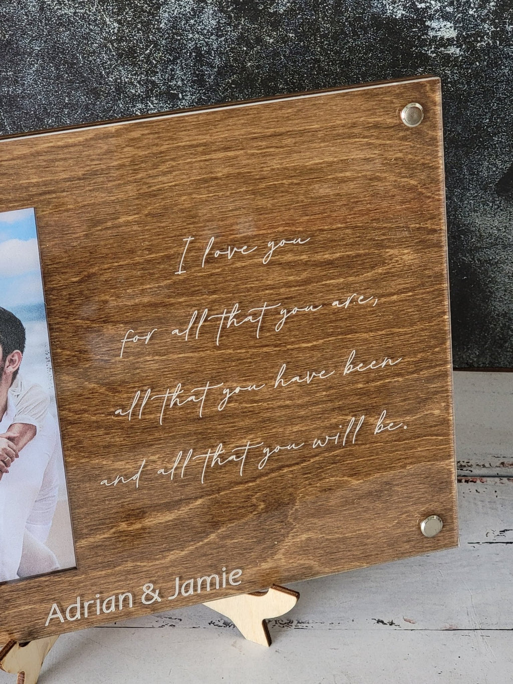 Close-up walnut engraved picture frame with cursive I love you quote and name Adrian & Jamie