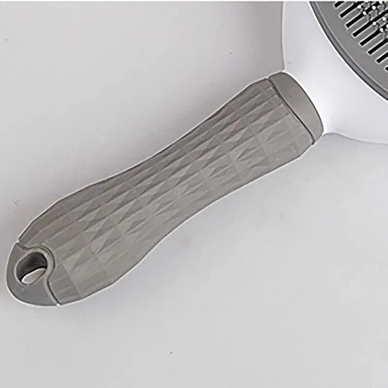 Gray textured, non-slip handle for pet grooming slicker brush with hanging loop.
