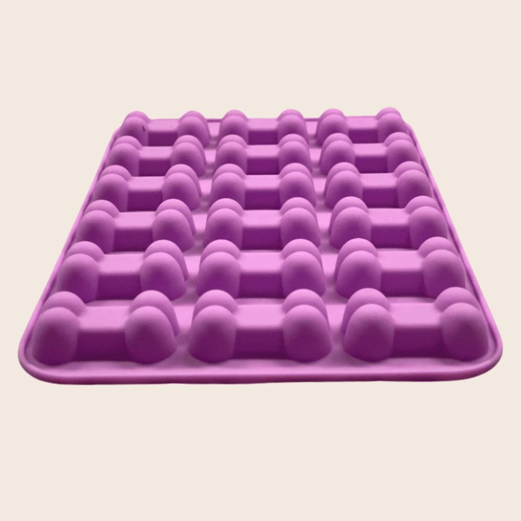 Purple silicone pet treat mold tray with rounded cavity rows for shaped treats