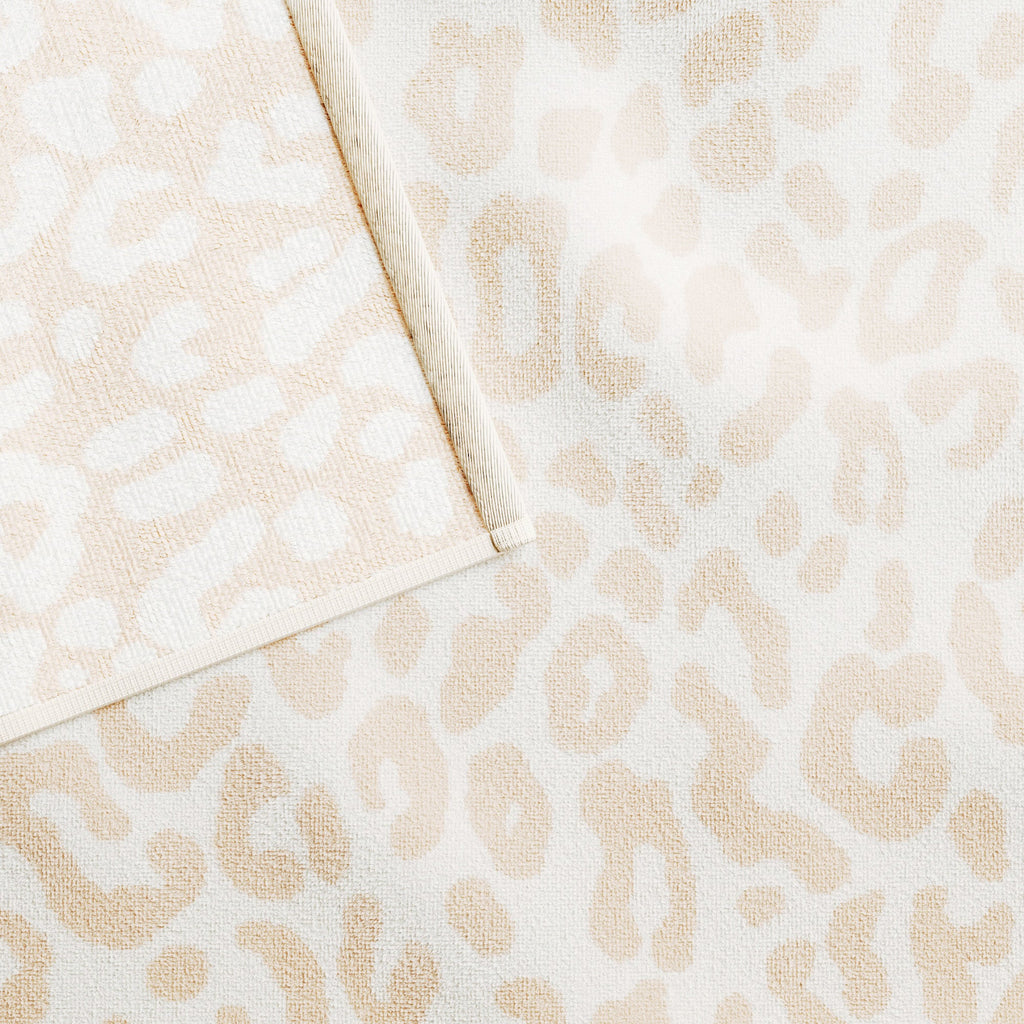 Beige and light tan cotton velour beach towel with small leopard-like pattern close-up