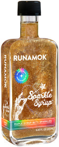 Sparkle maple syrup bottle with black cap, amber glitter syrup, front label visible.