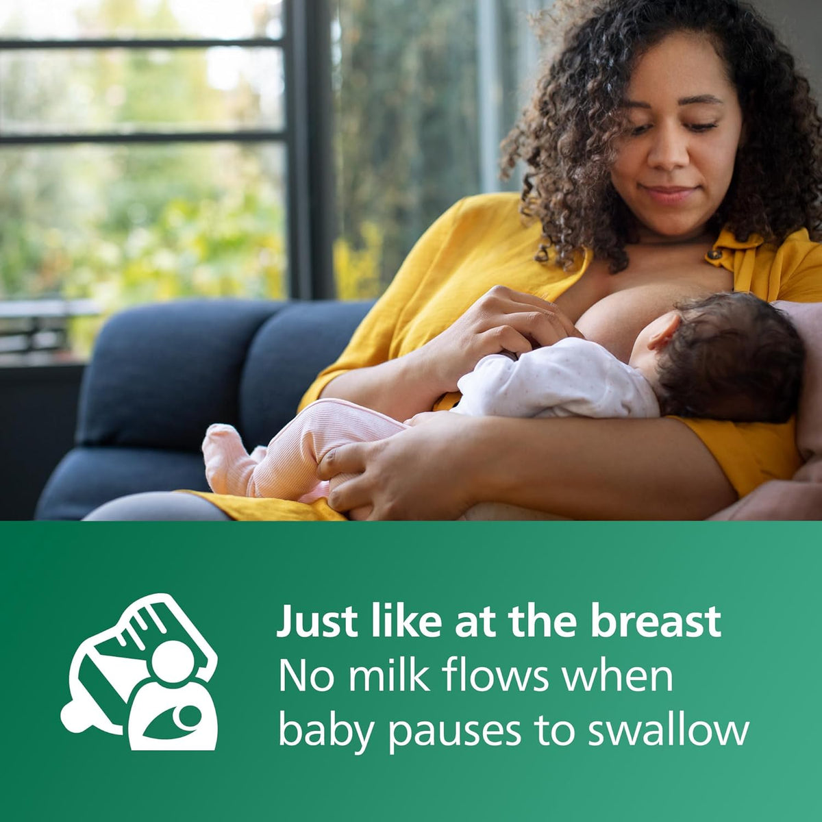 Baby bottle feeding with Natural Response nipple held to newborn during cuddle