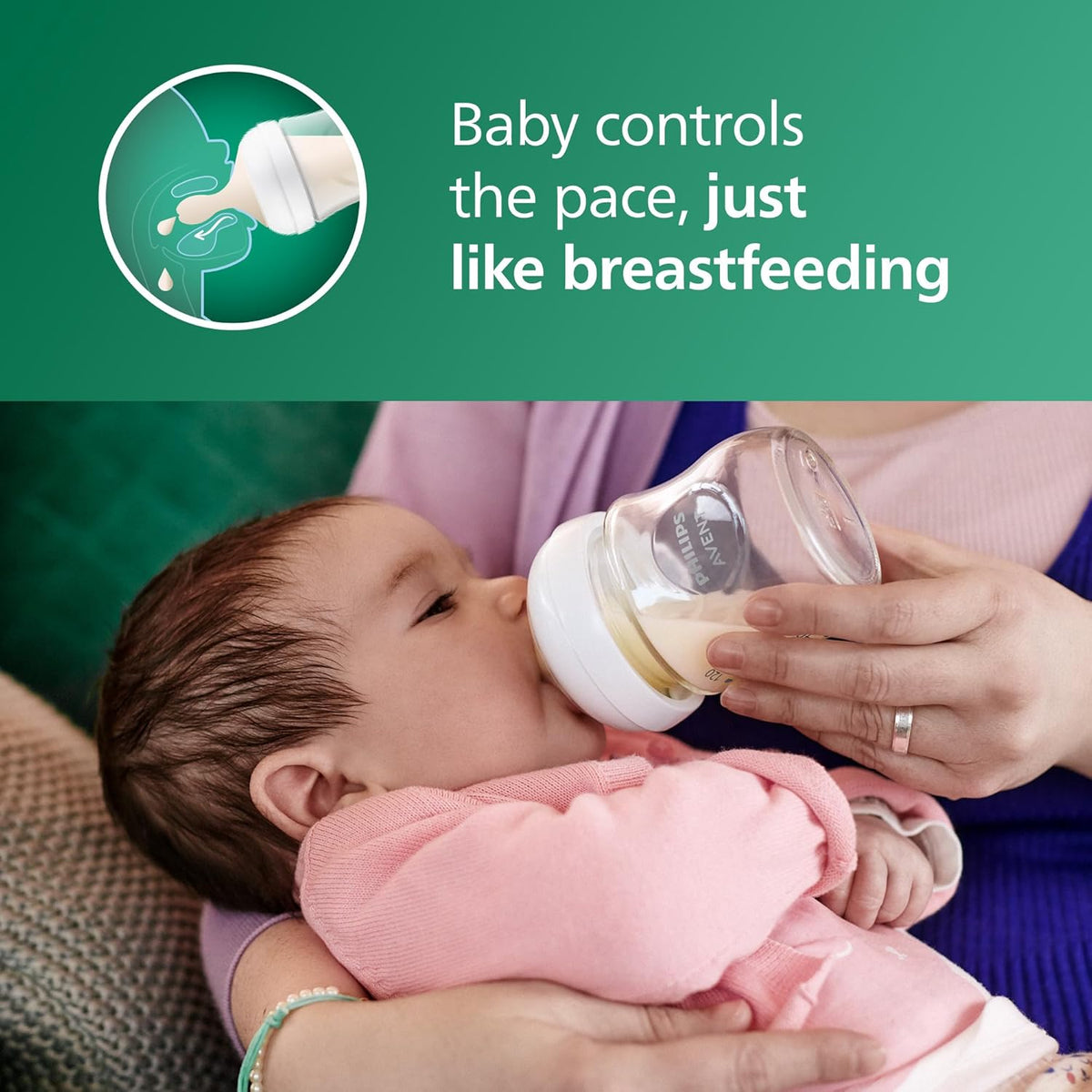 Baby bottle with Natural Response nipple held for feeding on a couch