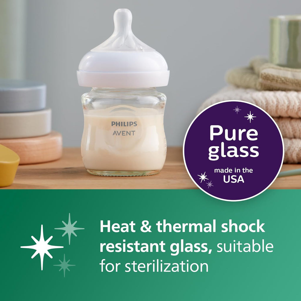 Clear glass baby bottle with Philips Avent label and soft nipple