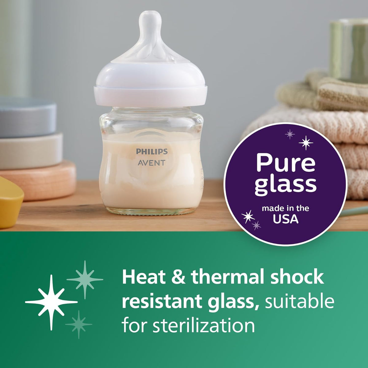 Clear glass baby bottle with Philips Avent label and soft nipple