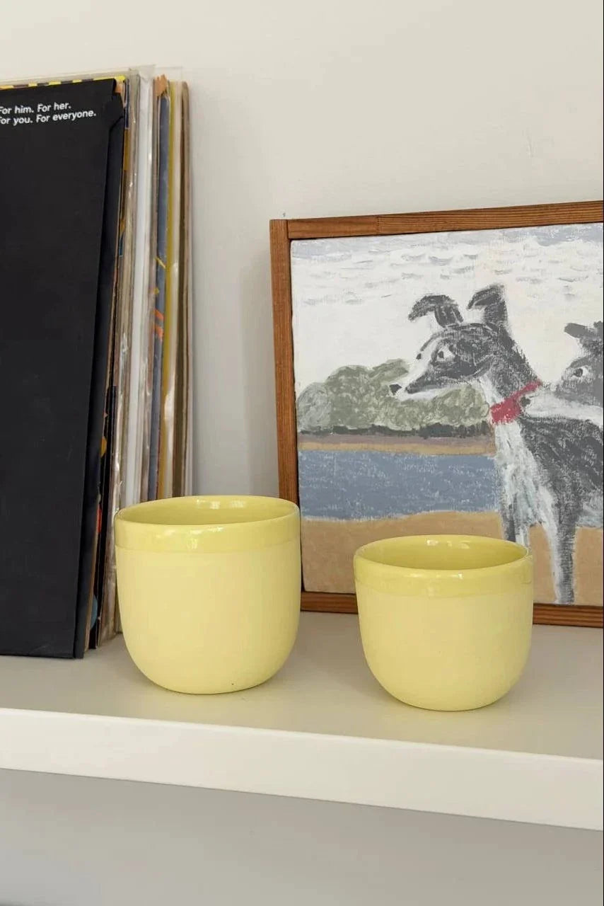 Lemon-yellow porcelain espresso cups on display, no saucers