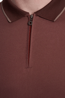 Brick polo close-up of ribbed collar and buttoned placket