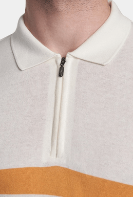 Cream knit polo with ribbed collar, quarter-zip placket, and orange stripe trim