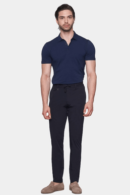 Navy polo shirt with short sleeves and collared neckline, back view on model