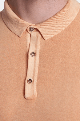Close-up of creamsicle orange polo collar and button placket