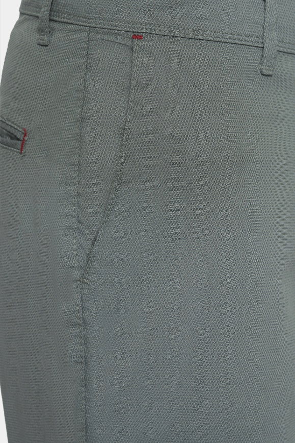 Close-up of seal green shorts: button fly, belt loops, textured fabric